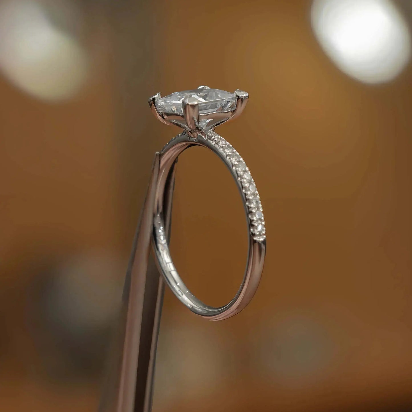 studio image of luxury princess white gold diamond set shoulders lab grown diamond engagement ring