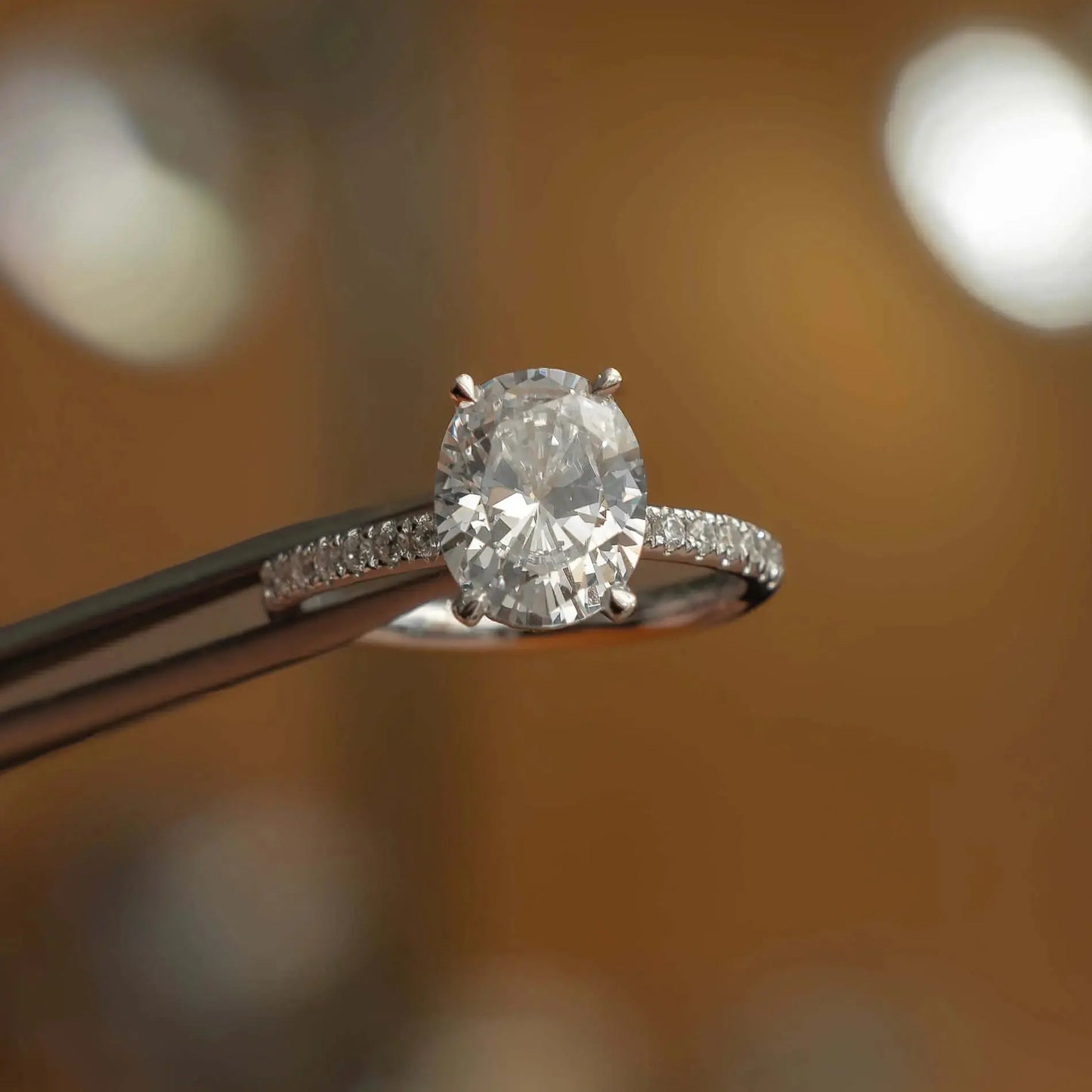 front image luxury oval platinum diamond set shoulders hidden halo lab grown diamond engagement ring