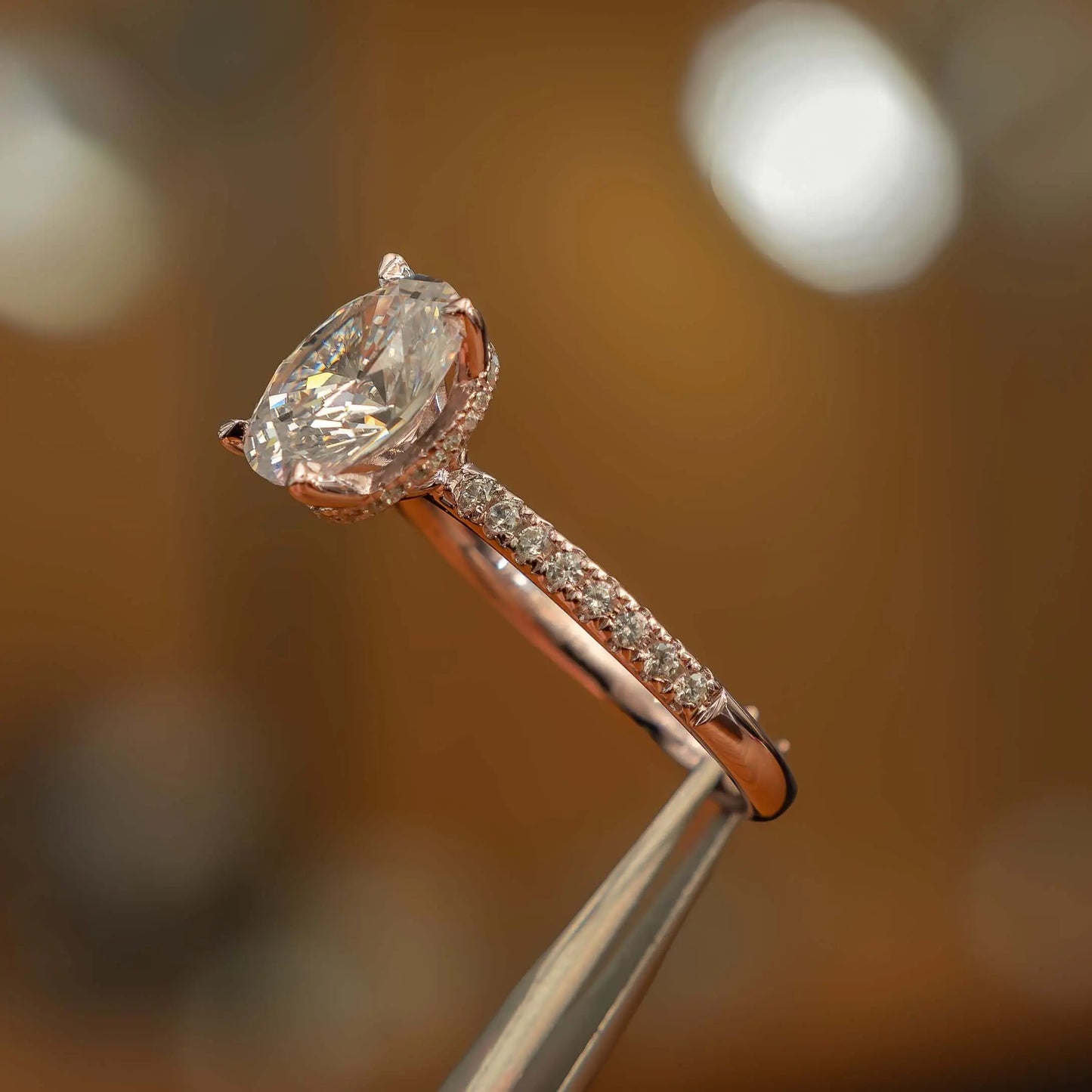 image of luxury oval rose gold diamond set shoulders hidden halo lab grown diamond engagement ring