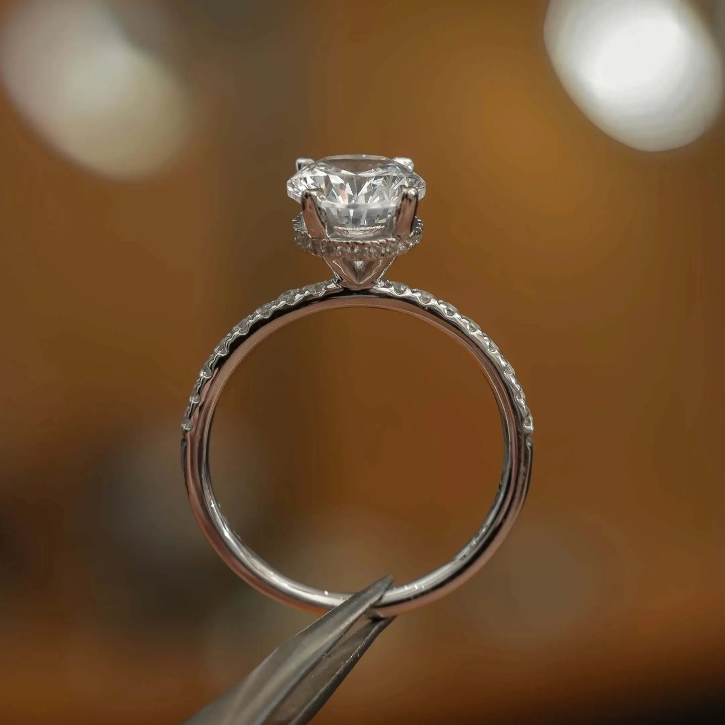 side image in studio of luxury oval platinum diamond set shoulders hidden halo lab grown diamond engagement ring