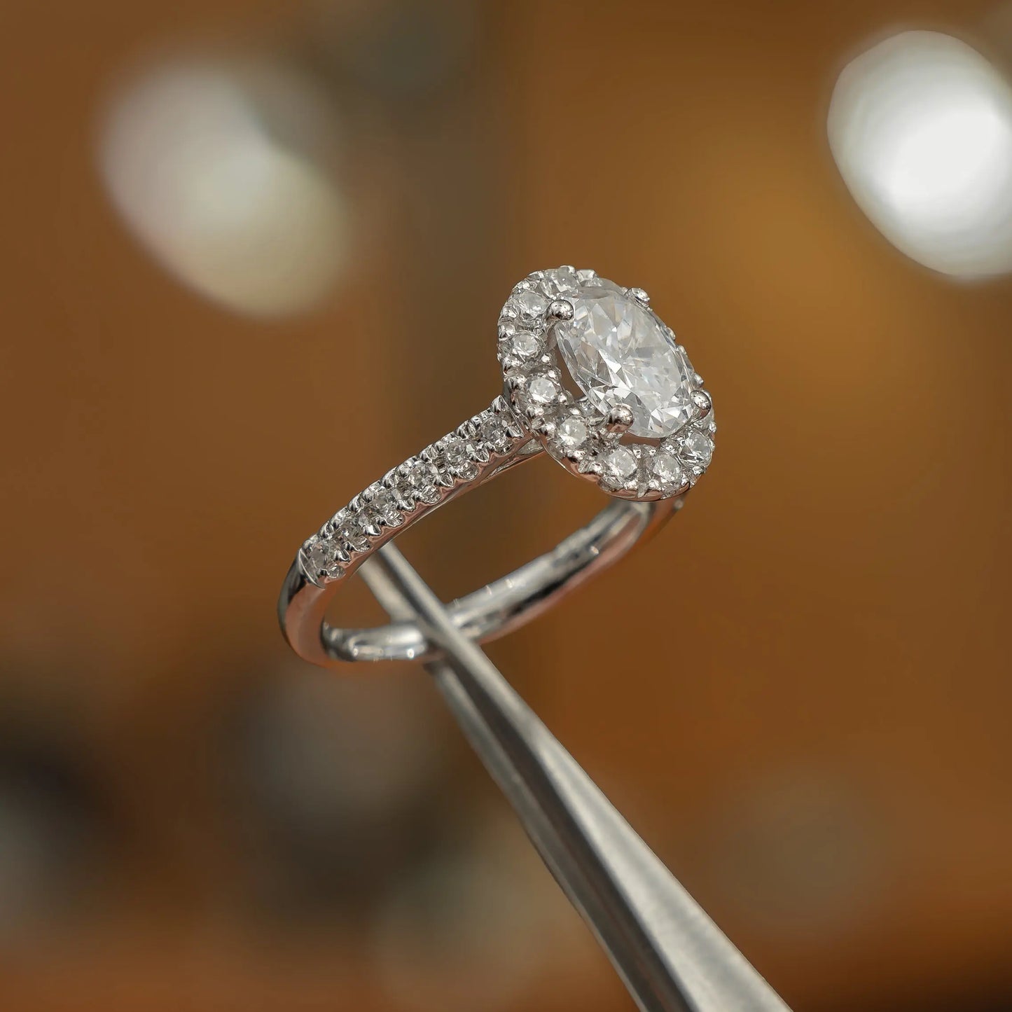 luxury oval white gold diamond set shoulders halo lab grown diamond engagement ring studio shot