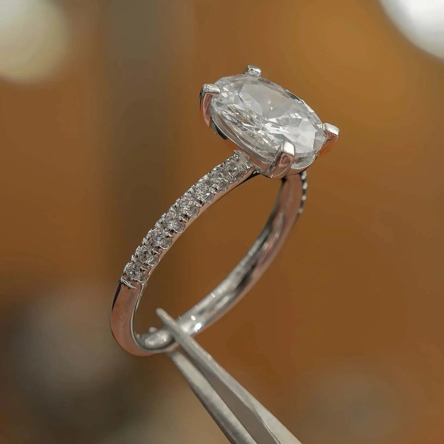 studio image of luxury oval platinum diamond set shoulders lab grown diamond engagement ring