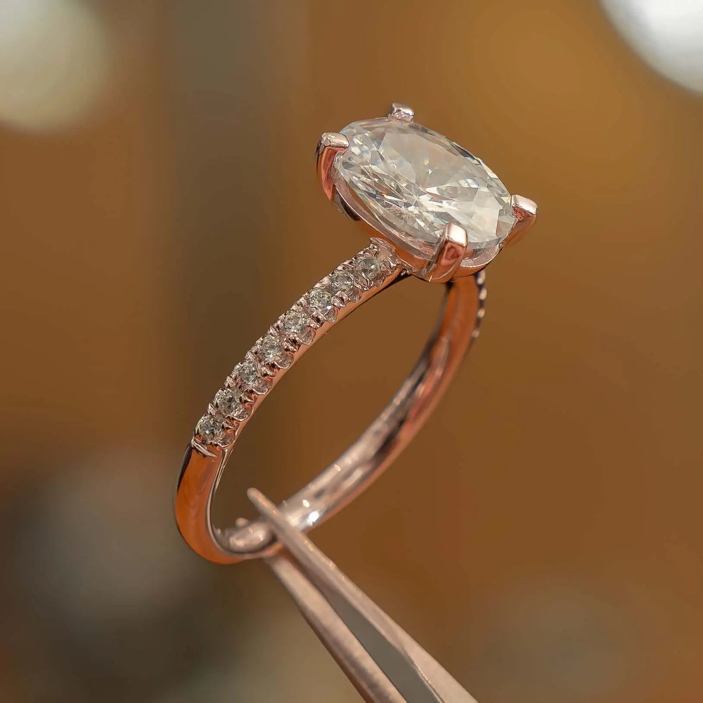 oval rose gold diamond set shoulders lab grown diamond engagement ring studio image