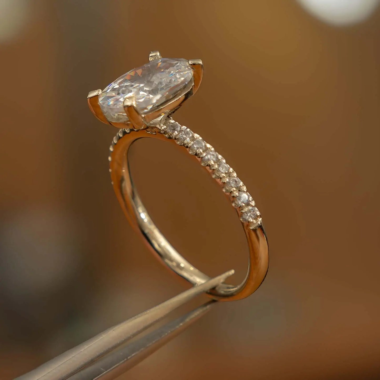 right side view oval yellow gold diamond set shoulders lab grown diamond engagement ring