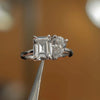 luxury emerald and pear platinum lab grown diamond pair engagement ring in studio