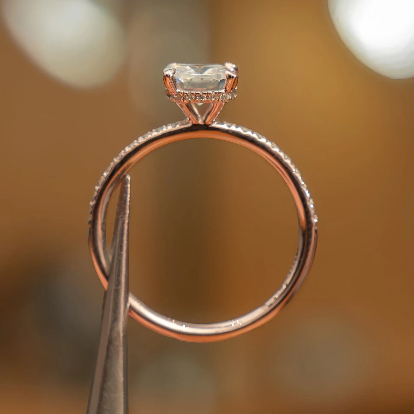 side image of luxury cushion rose gold diamond set shoulders hidden halo lab grown diamond engagement ring