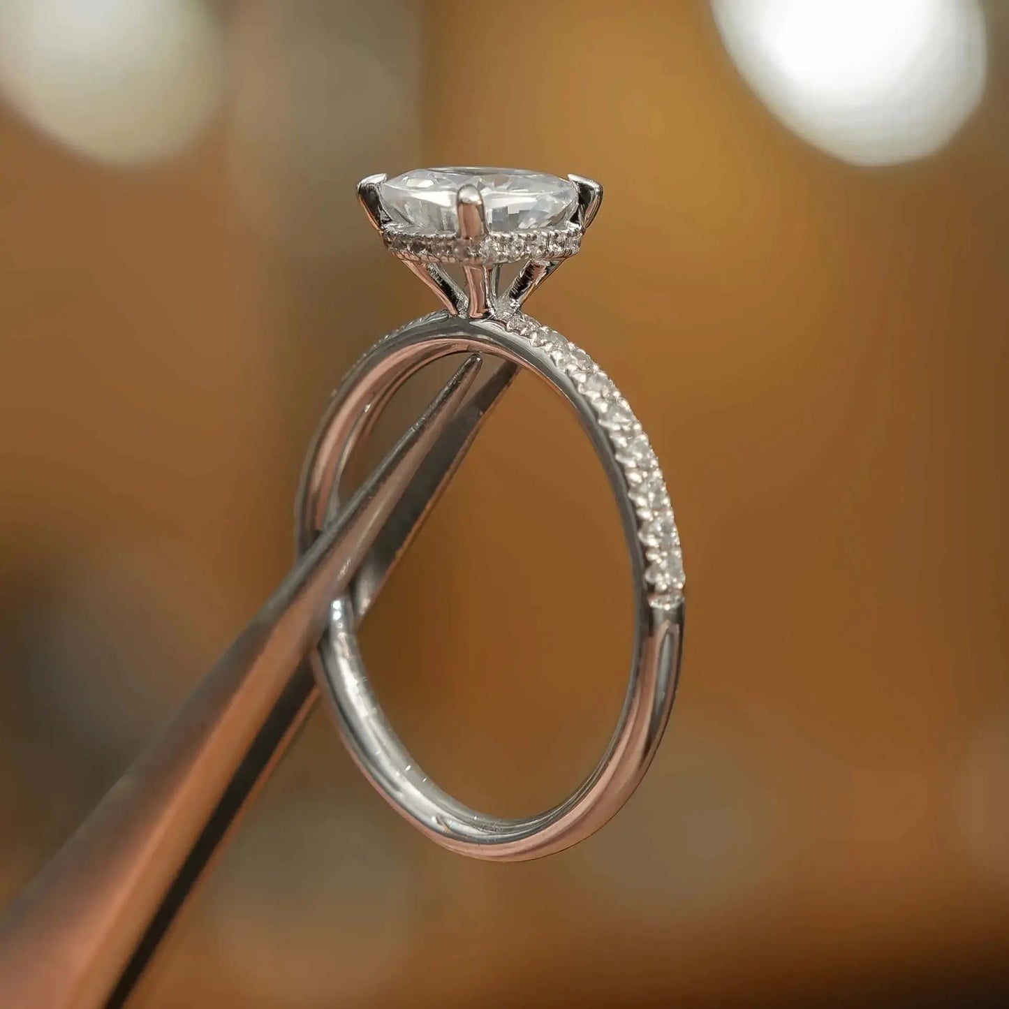 studio picture of luxury cushion platinum diamond set shoulders hidden halo lab grown diamond engagement ring