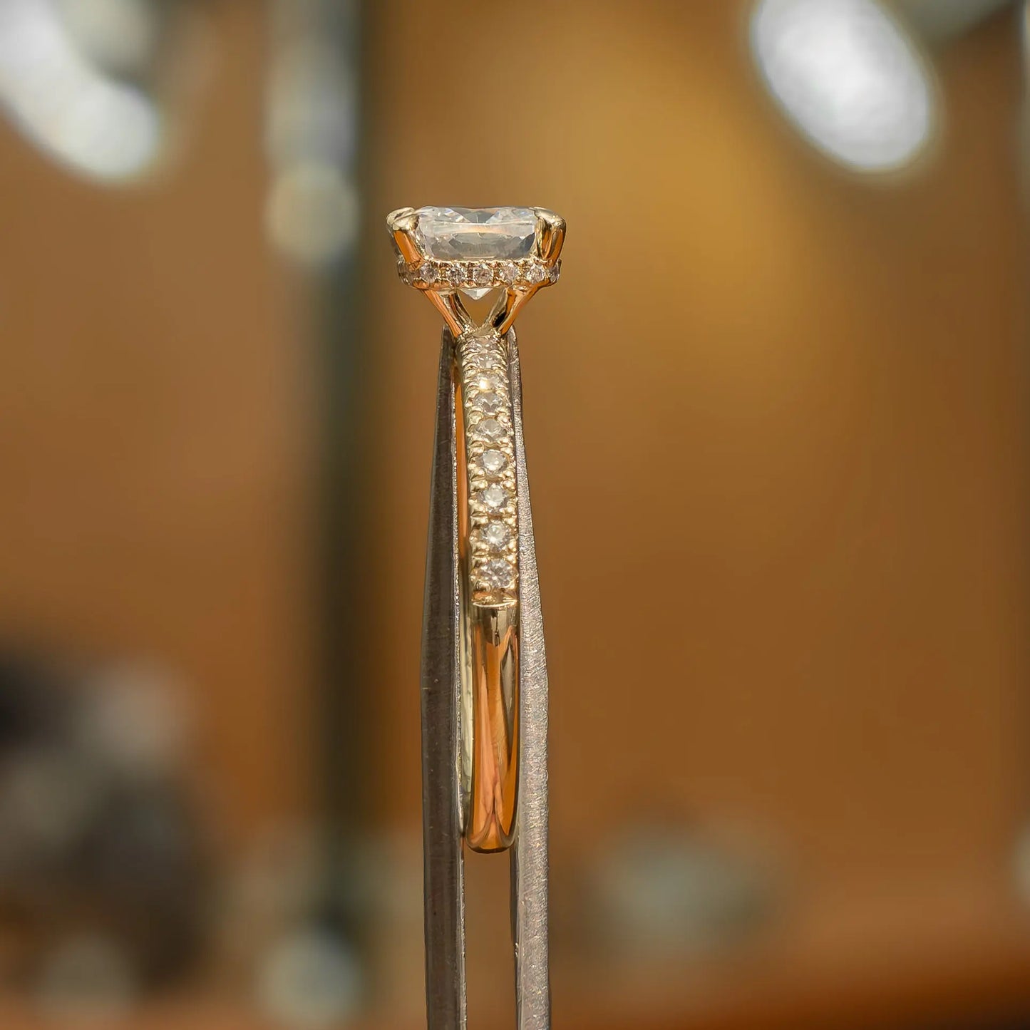 side image of luxury cushion yellow gold diamond set shoulders hidden halo lab grown diamond engagement ring