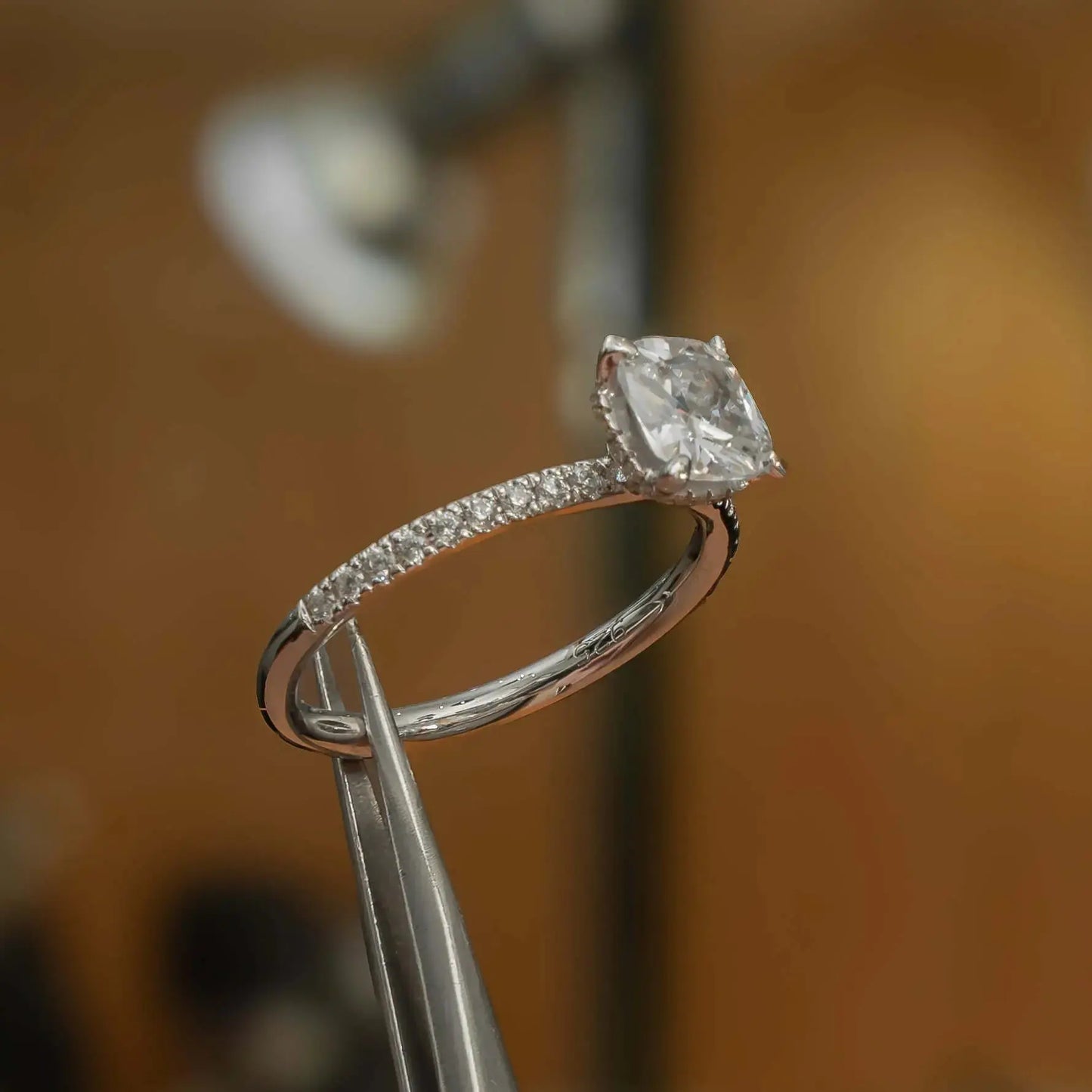 studio shot luxury cushion platinum diamond set shoulders hidden halo lab grown diamond engagement ring