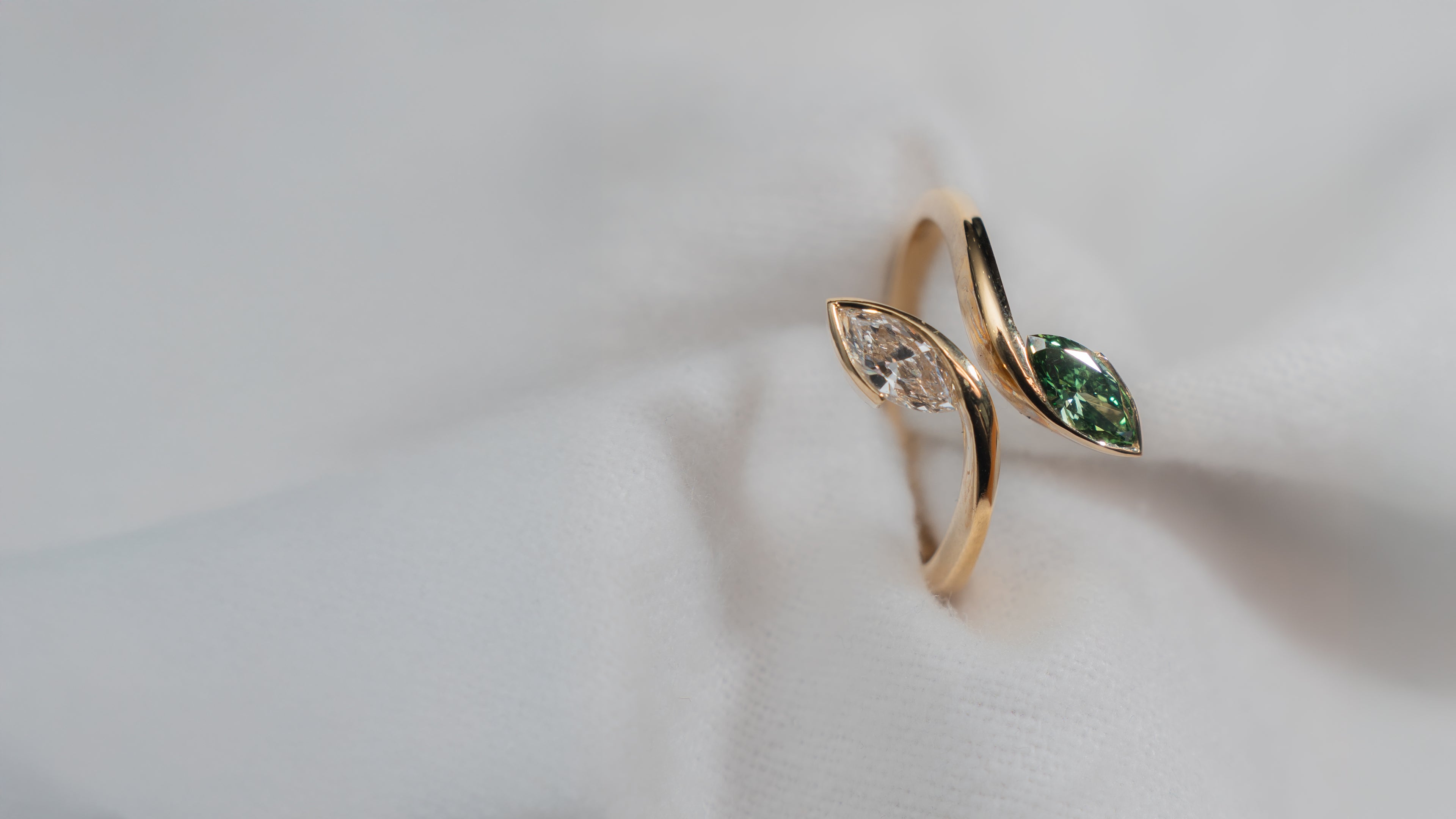 yellow gold ring with green and white labs