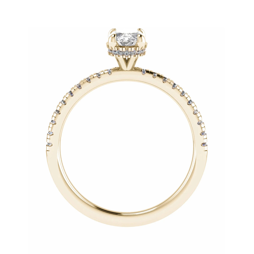 side image in studio of luxury oval yellow gold diamond set shoulders hidden halo lab grown diamond engagement ring