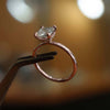 studio shot of luxury cushion rose gold hidden halo solitaire lab grown diamond engagement ring
