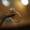 studio image of luxury cushion yellow gold hidden halo solitaire lab grown diamond engagement ring