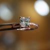studio image of luxury cushion rose gold hidden halo solitaire lab grown diamond engagement ring