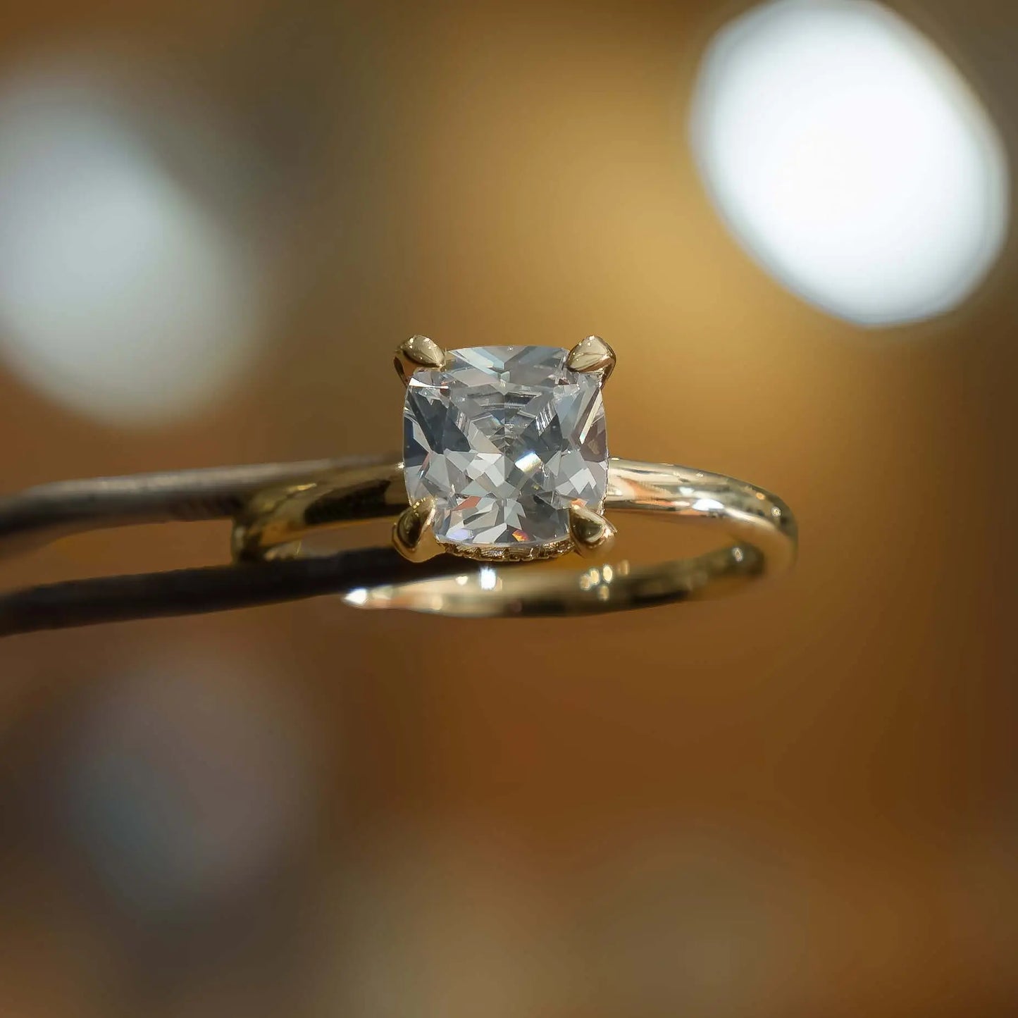 studio image of luxury cushion yellow gold hidden halo solitaire lab grown diamond engagement ring