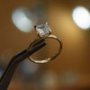 studio image of luxury cushion yellow gold hidden halo solitaire lab grown diamond engagement ring