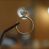studio shot of luxury cushion yellow gold hidden halo solitaire lab grown diamond engagement ring