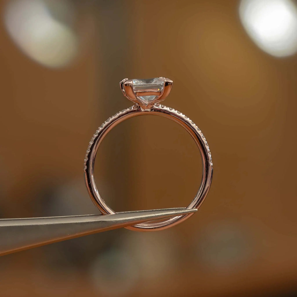 studio image holding princess rose gold diamond set shoulders lab grown diamond engagement ring
