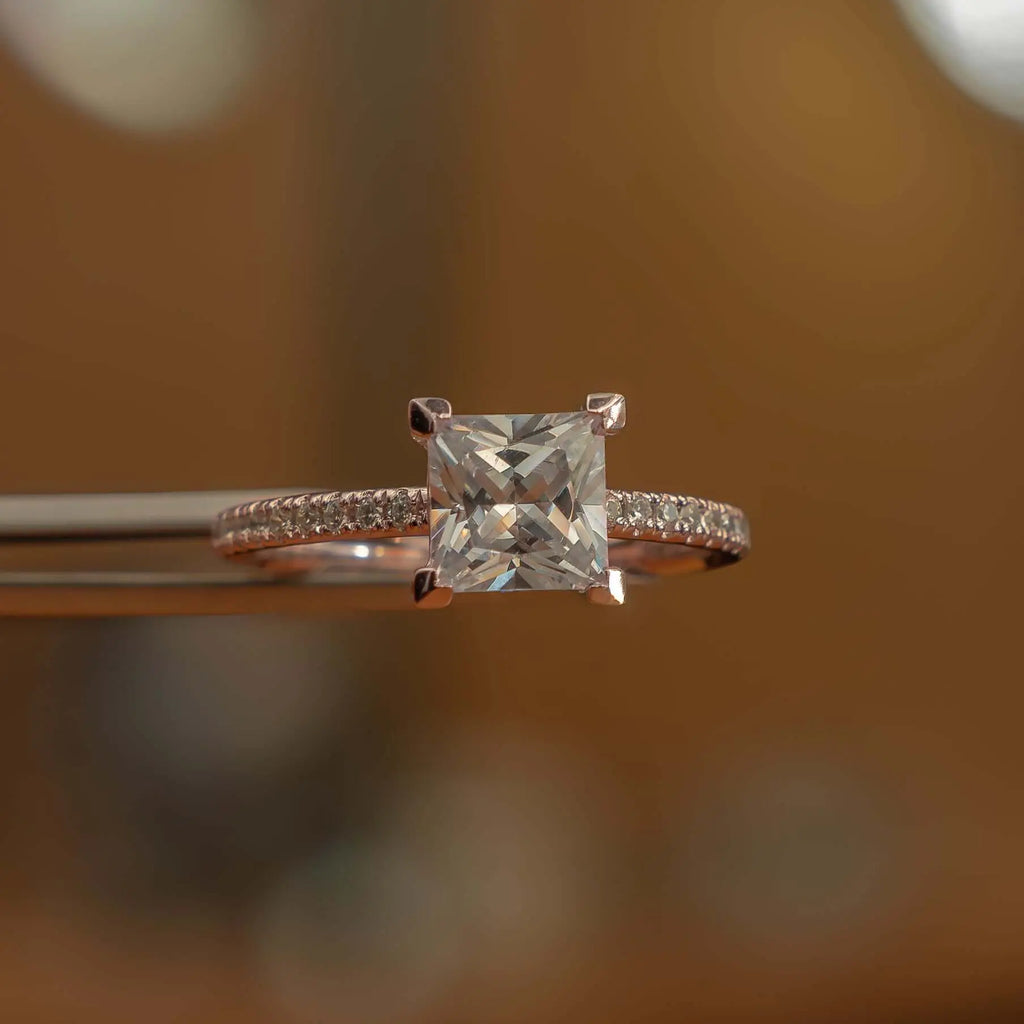 frontal studio image of luxury princess rose gold diamond set shoulders lab grown diamond engagement ring