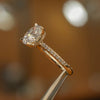 image of luxury oval yellow gold diamond set shoulders hidden halo lab grown diamond engagement ring