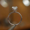 side image in studio of luxury oval platinum diamond set shoulders hidden halo lab grown diamond engagement ring
