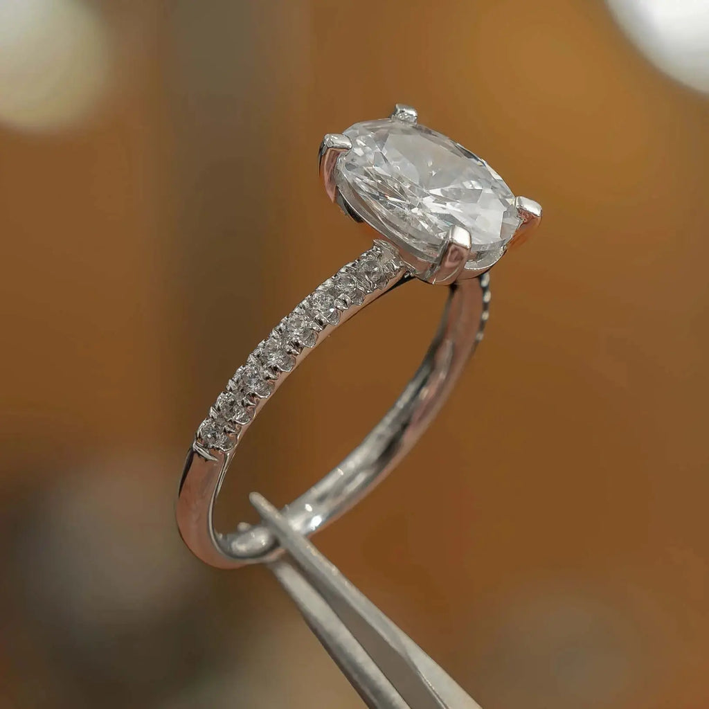 studio image of luxury oval platinum diamond set shoulders lab grown diamond engagement ring