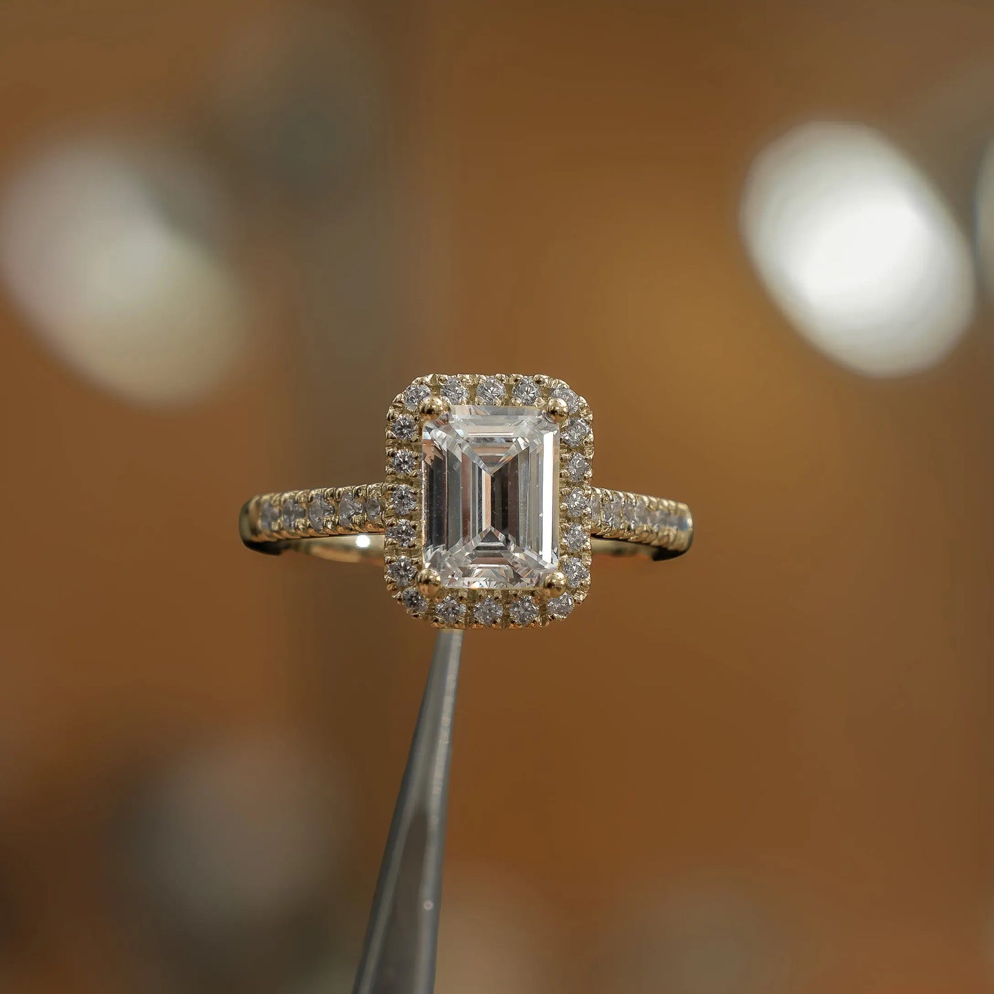 frontal view in studio of luxury emerald yellow gold diamond halo lab grown diamond engagement ring