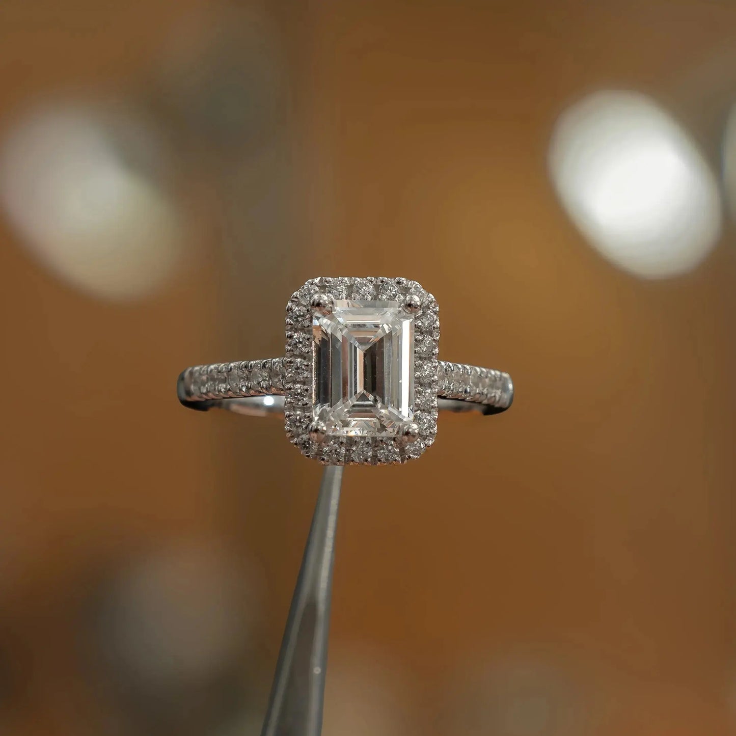 frontal view in studio of luxury emerald white gold diamond halo lab grown diamond engagement ring