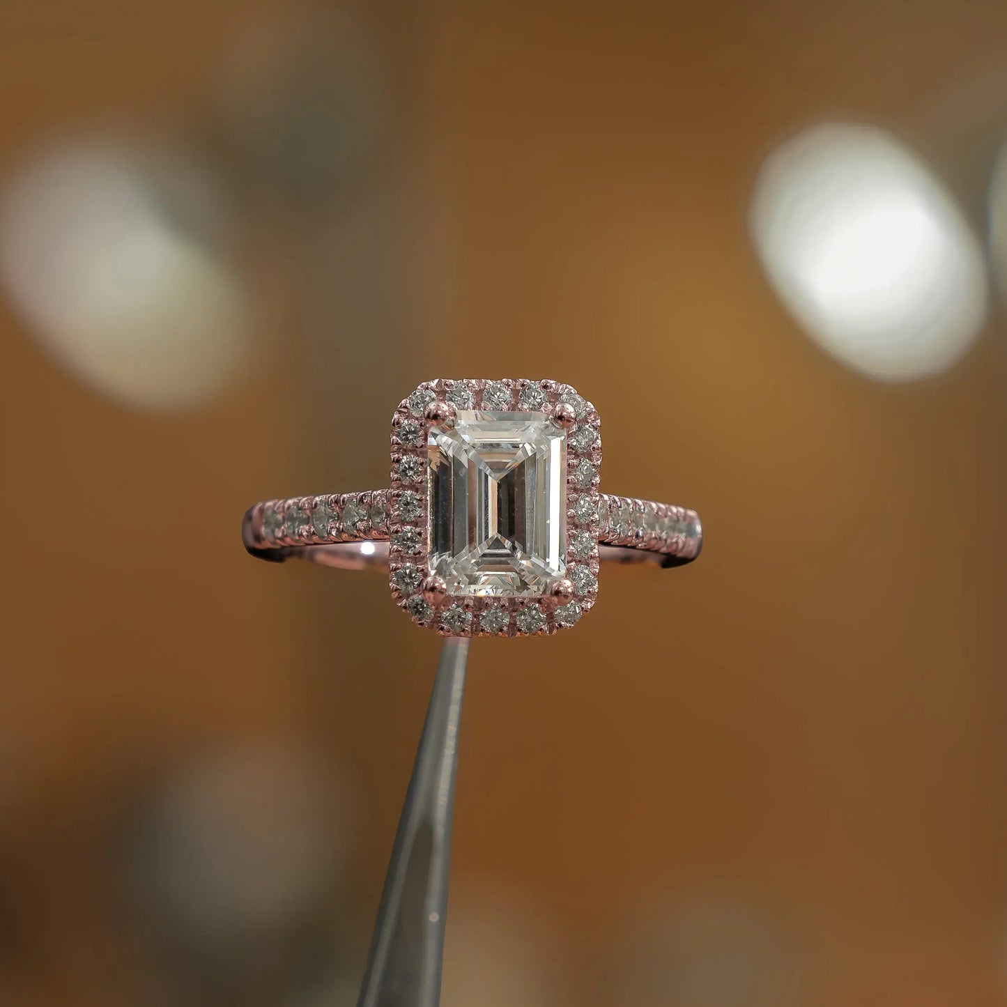 studio image of emerald luxury rose gold halo lab grown diamond engagement ring