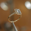 side view luxury emerald yellow gold diamond halo lab grown diamond engagement ring in studio