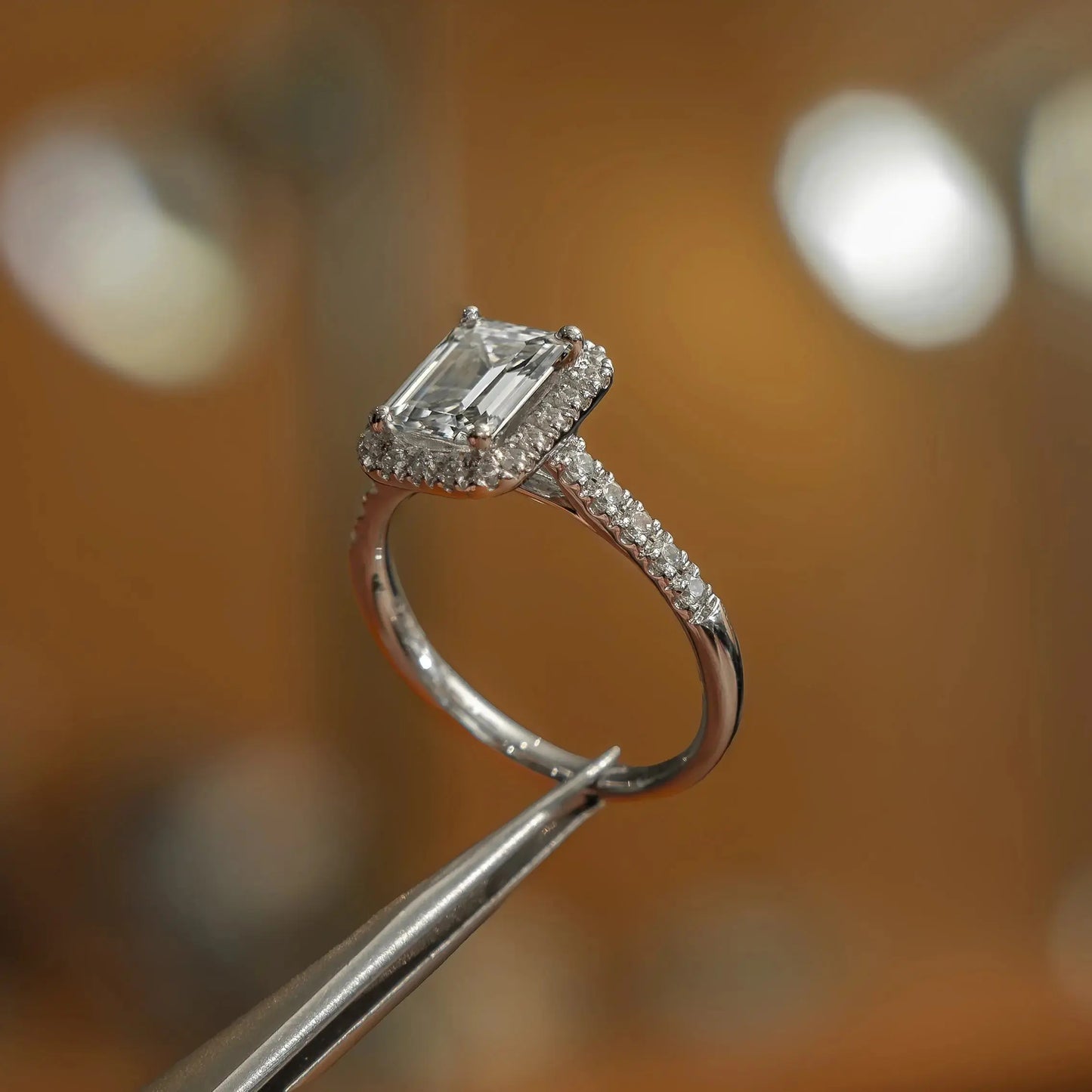 frontal side view luxury emerald white gold diamond halo lab grown diamond engagement ring in studio