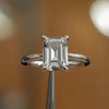 frontal view luxury emerald platinum solitaire lab grown diamond engagement ring in studio