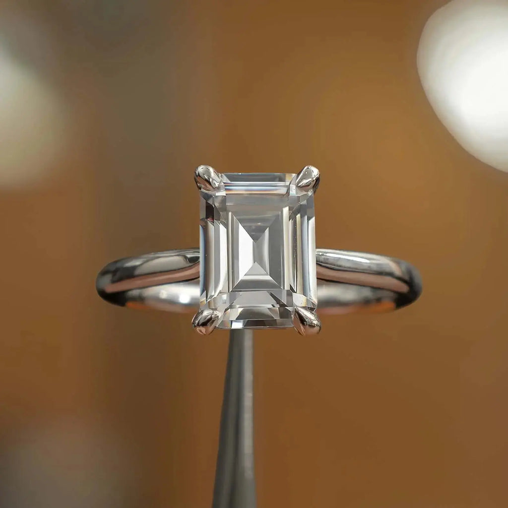 frontal view luxury emerald platinum solitaire lab grown diamond engagement ring in studio