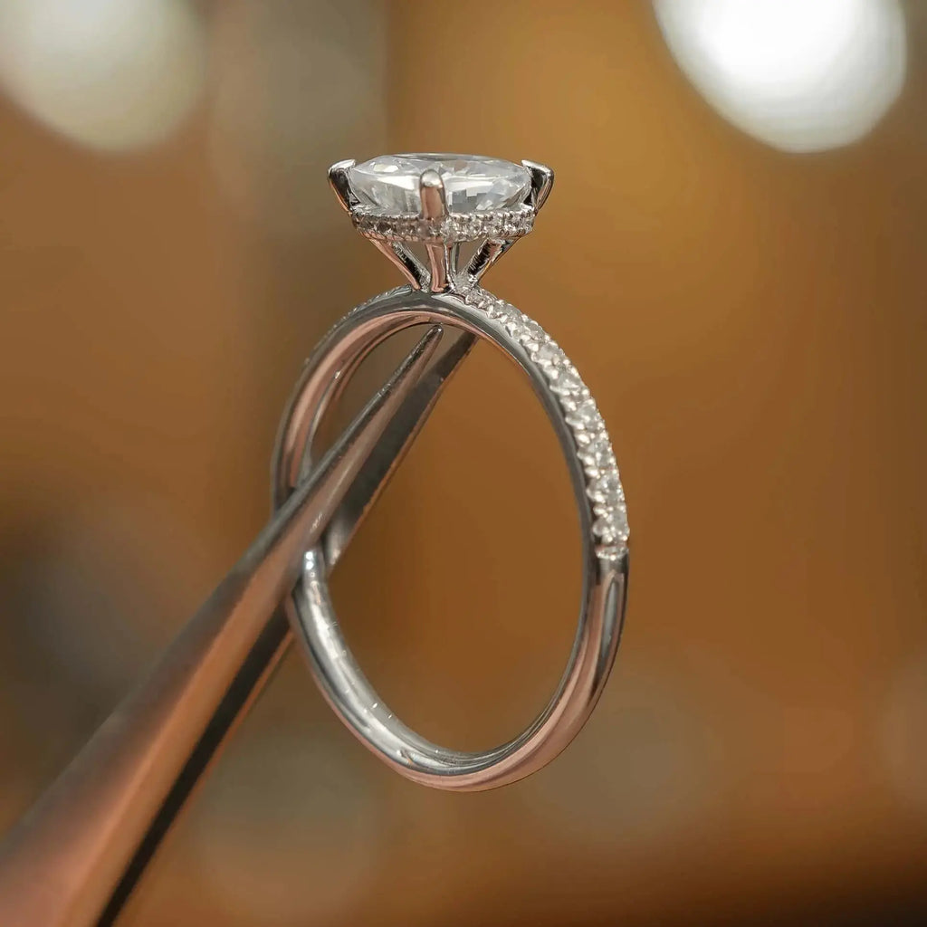 studio picture of luxury cushion platinum diamond set shoulders hidden halo lab grown diamond engagement ring