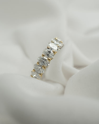 Gold and diamond earring on a light fabric background