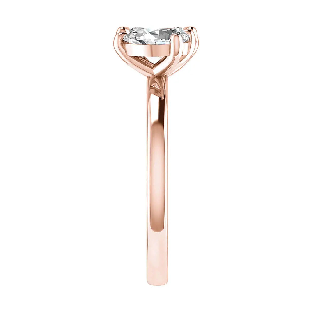 side angle luxury emerald and pear rose gold lab grown diamond pair engagement ring