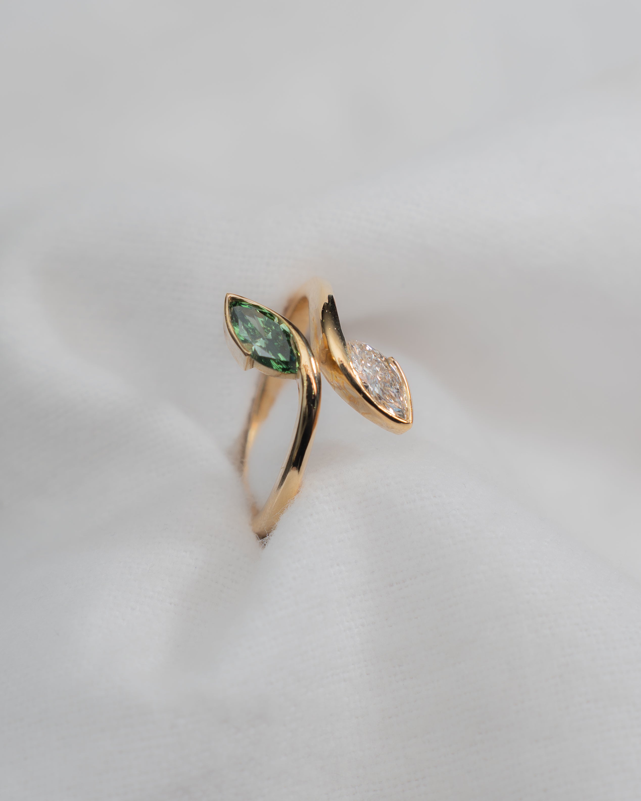 yellow gold ring with green and white labs